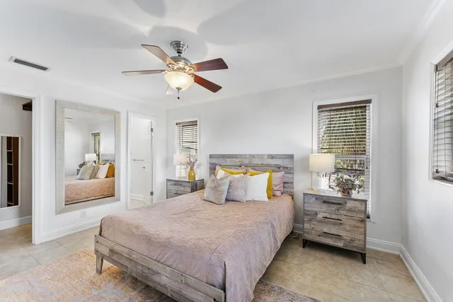 a bedroom with a large bed and a chandelier
