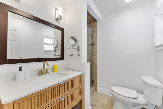 a bathroom with a sink a toilet and mirror