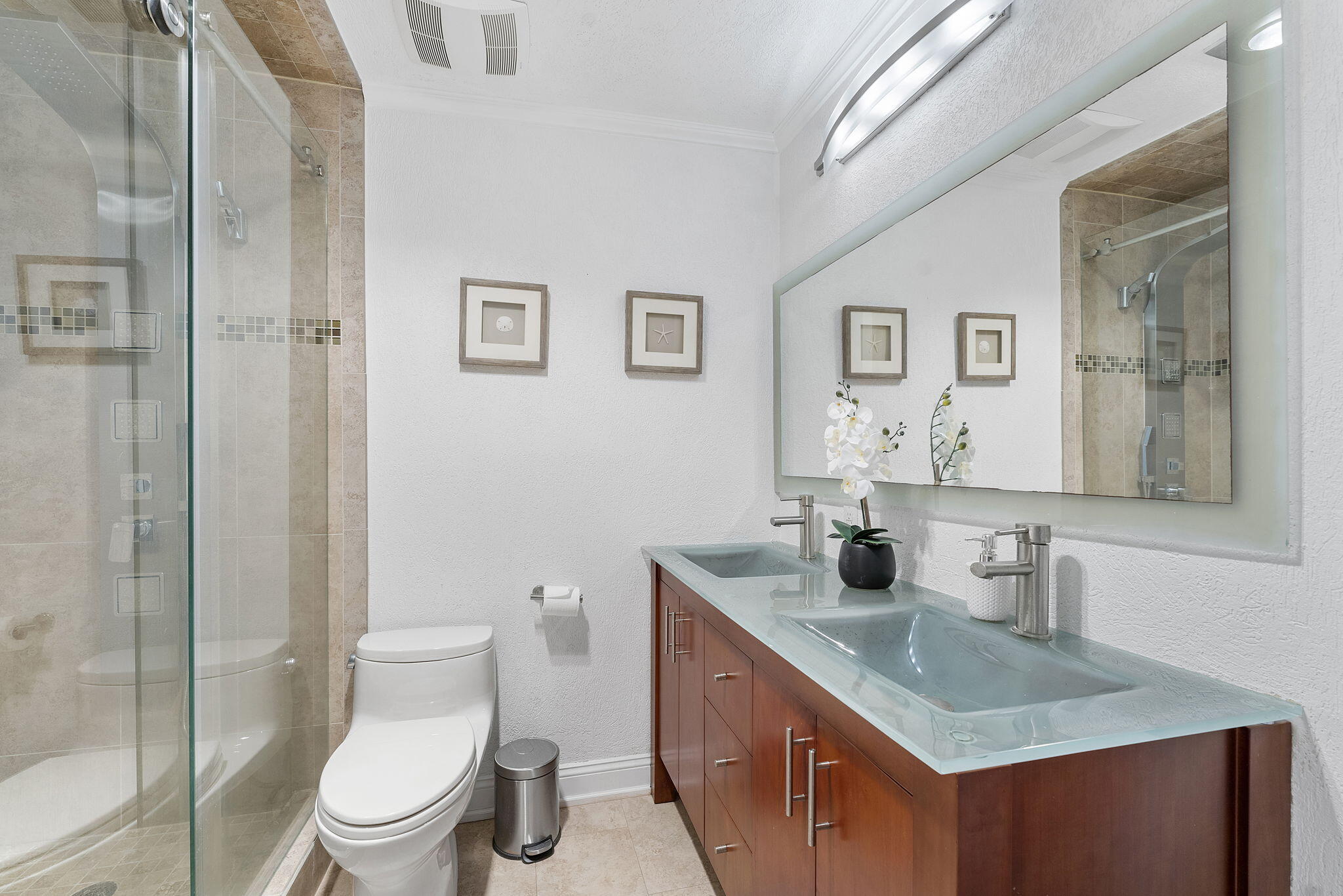 3200 Northeast 10th Street, Unit 7 Pompano Beach, FL 33062 - Photo 19 of 27 a bathroom with a toilet a sink a mirror and shower