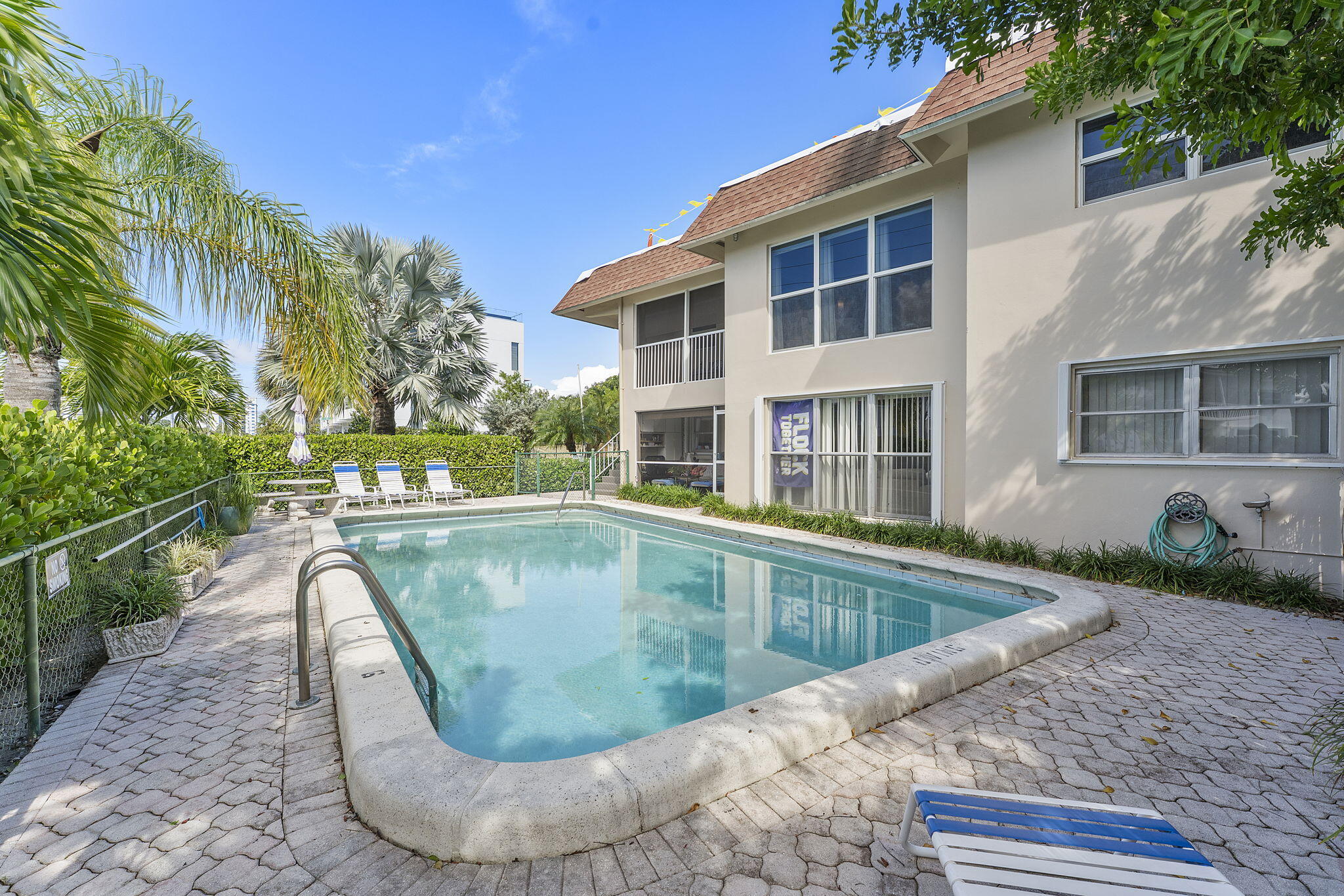 3200 Northeast 10th Street, Unit 7 Pompano Beach, FL 33062 - Photo 26 of 27 front view of a house with a swimming pool