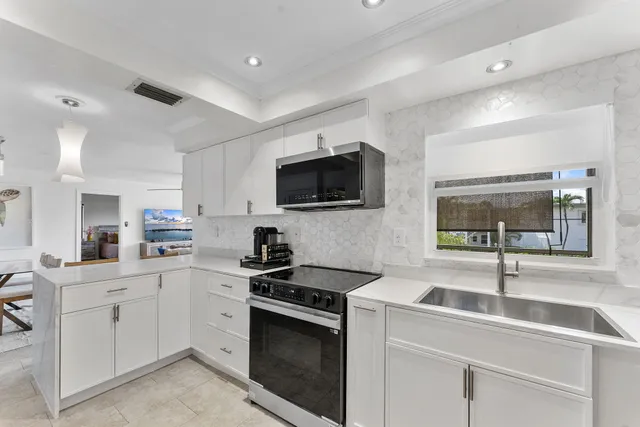 a kitchen with a sink stove and microwave