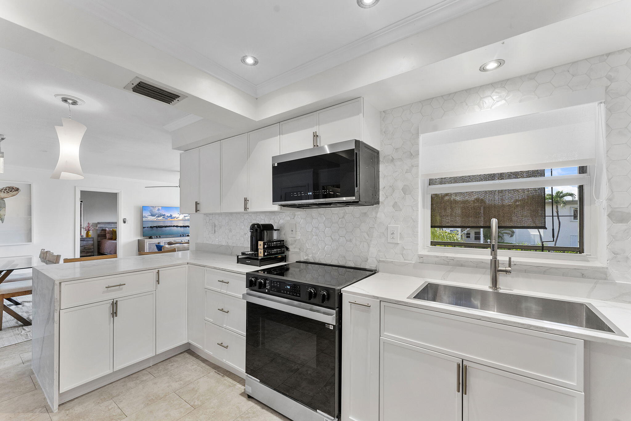 3200 Northeast 10th Street, Unit 7 Pompano Beach, FL 33062 - Photo 4 of 27 a kitchen with a sink stove and microwave