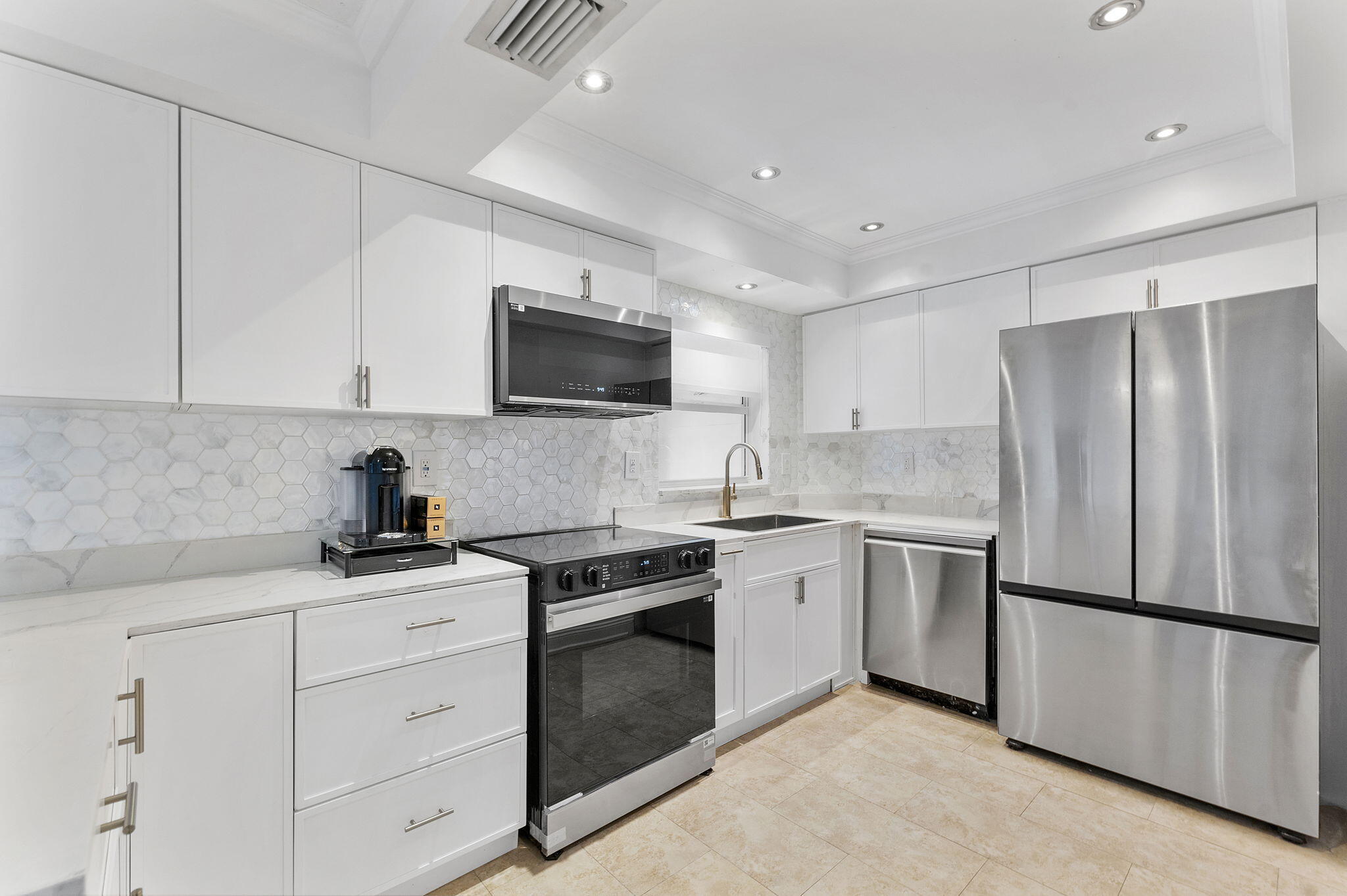 3200 Northeast 10th Street, Unit 7 Pompano Beach, FL 33062 - Photo 5 of 27 a kitchen with a sink stove and refrigerator