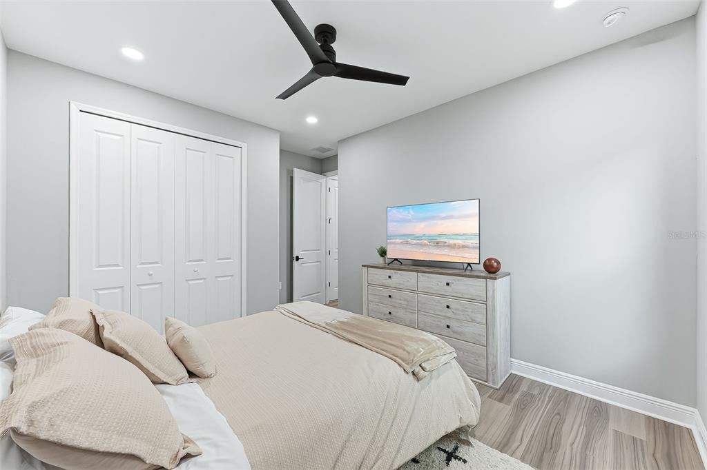 4191 Pegasus Way Naples, FL 34120 - Photo 27 of 48 a bedroom with a bed and a flat screen tv