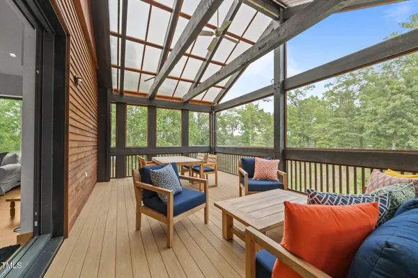 a living room with furniture and floor to ceiling windows