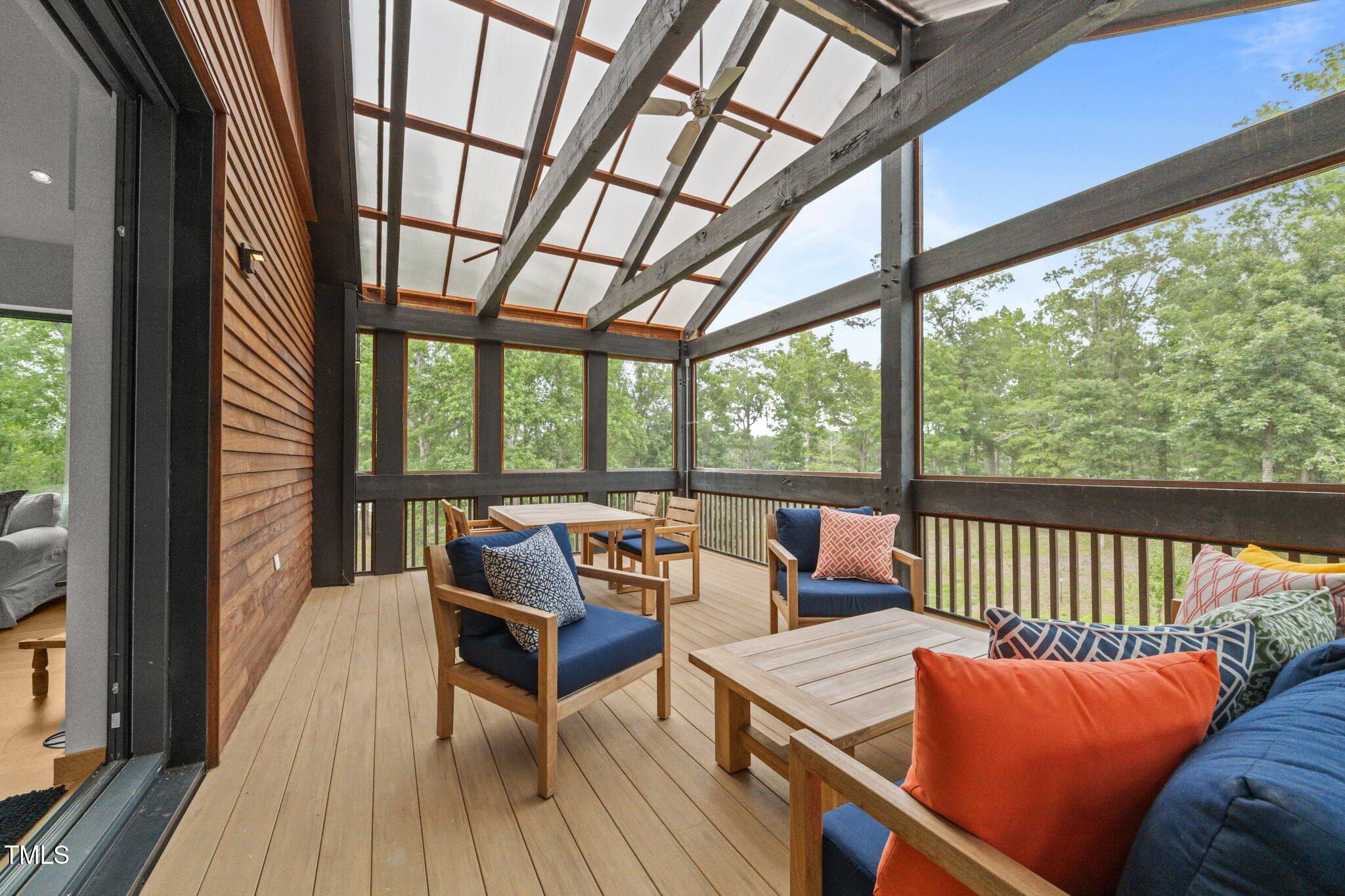 4725 Creeks Junction Road Blounts Creek, NC 27814 - Photo 24 of 42 a living room with furniture and floor to ceiling windows