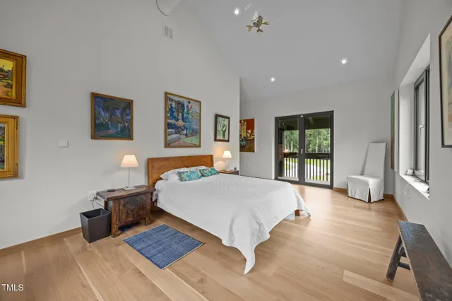 a spacious bedroom with a large bed and a window