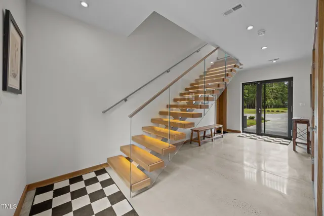 a view of staircase with wooden floor and fence
