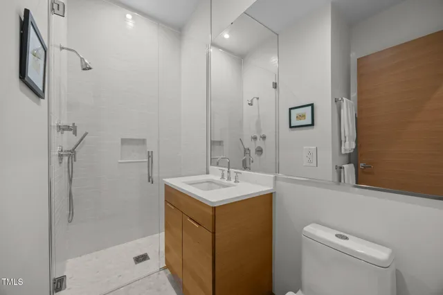 a bathroom with a sink a toilet and shower