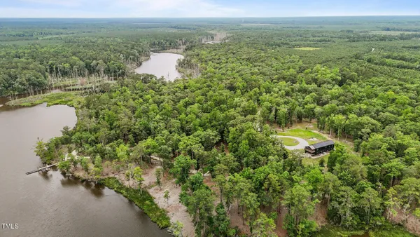 a view of a green yard with a lake