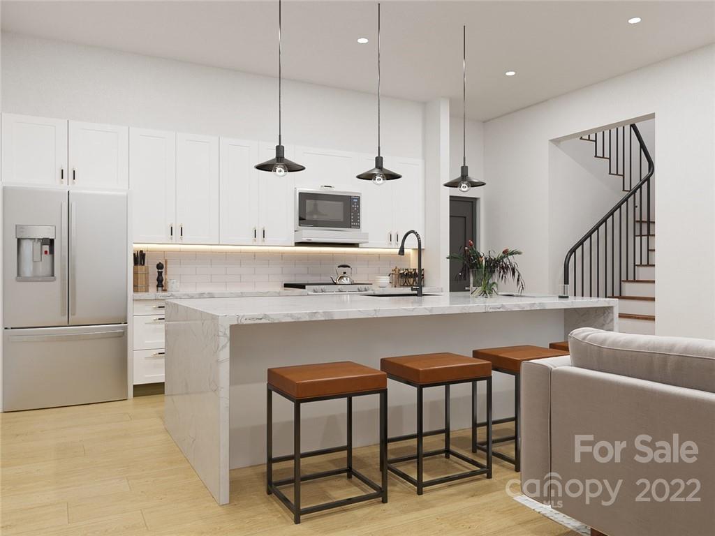 a kitchen with kitchen island a stove a sink and a refrigerator
