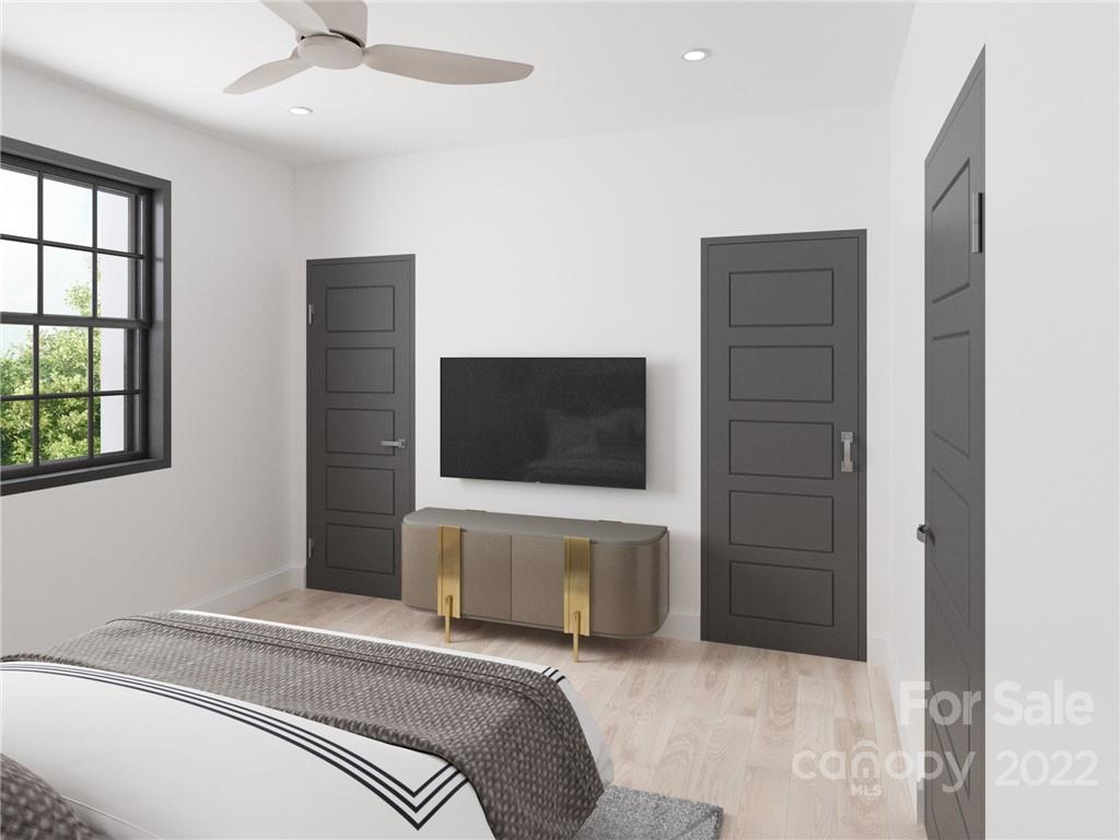 201 Grandin Road, Unit 7 Charlotte, NC 28208 - Photo 6 of 12 a bedroom with a bed and a flat screen tv