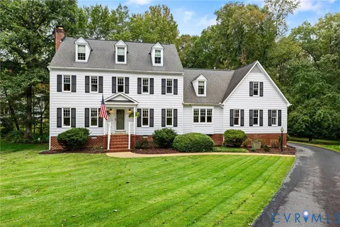 a front view of a house with garden and porch
