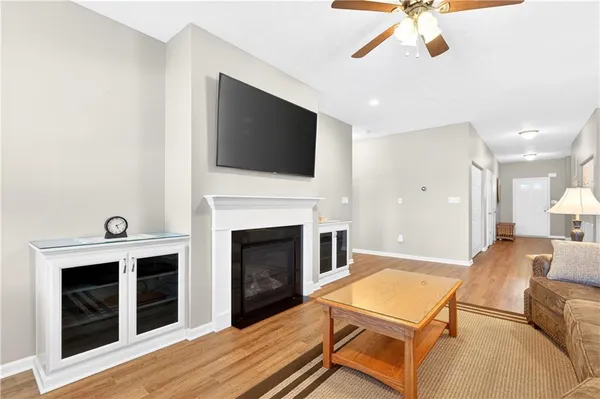 a living room with furniture a flat screen tv and a fireplace