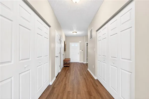 a view of a hallway with wooden floor