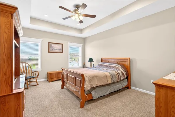 a spacious bedroom with a bed and a chandelier
