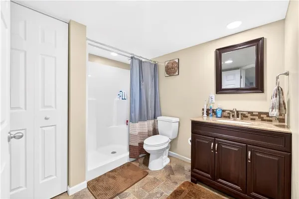 a bathroom with a sink toilet and shower