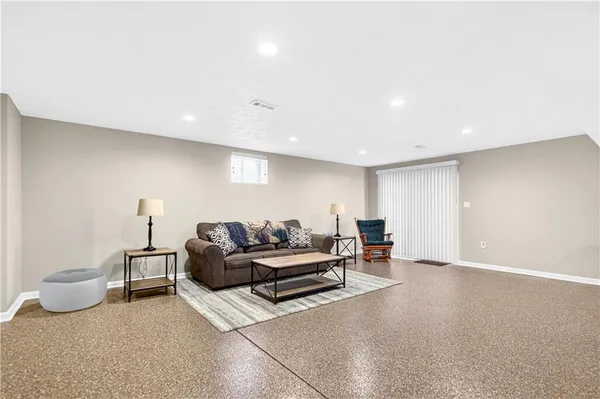 a living room with fireplace and a flat screen tv