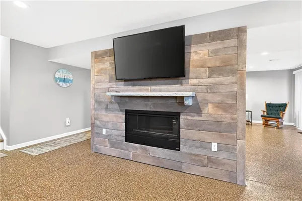 a living room with furniture a fireplace and a bookshelf