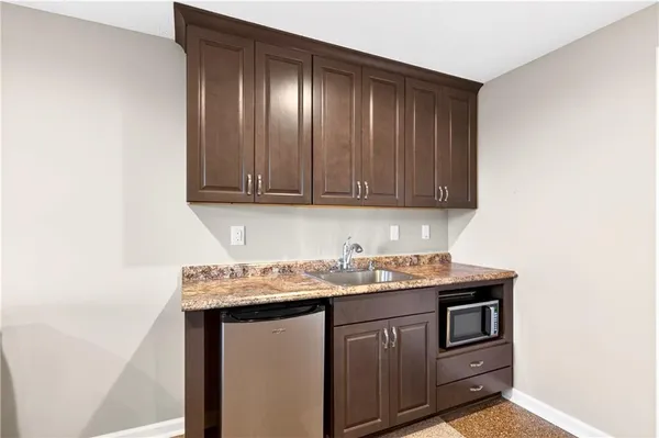 a kitchen with sink refrigerator and cabinets