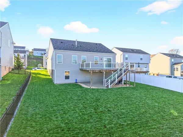 a view of a house with a backyard