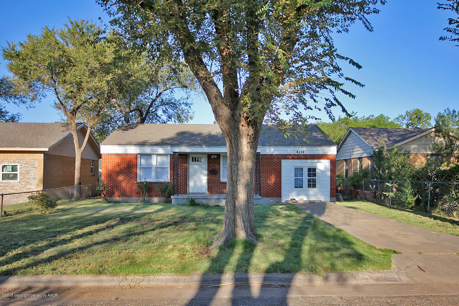 4214 South Travis Street Amarillo, TX 79110 - Photo 1 of 17 front view of a house with a yard