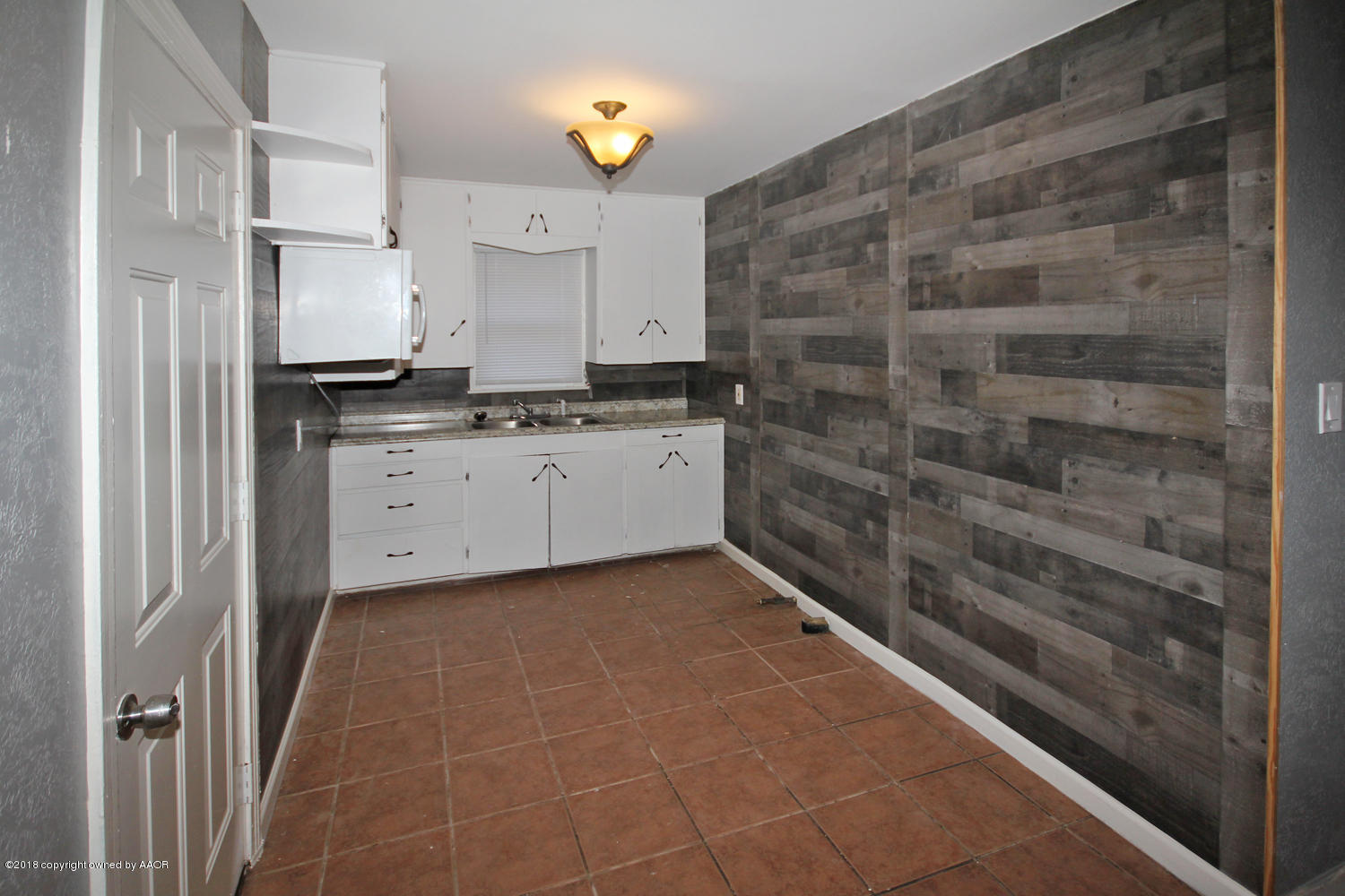 4214 South Travis Street Amarillo, TX 79110 - Photo 5 of 17 a kitchen with granite countertop a sink and a stove