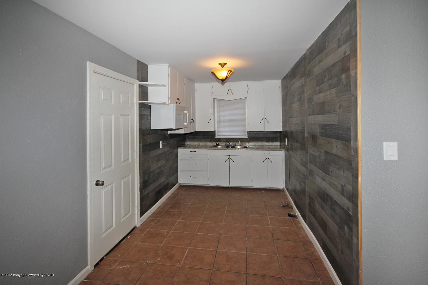 4214 South Travis Street Amarillo, TX 79110 - Photo 6 of 17 a kitchen with cabinets and window