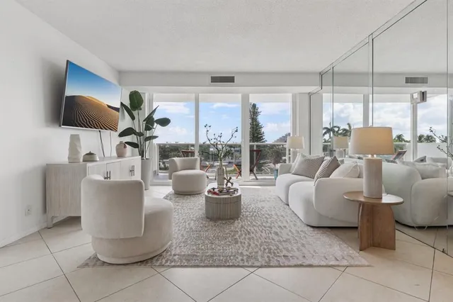 a living room with furniture and floor to ceiling window