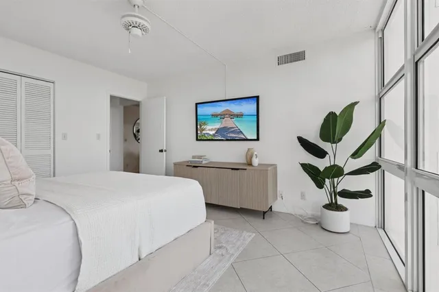 a bedroom with bed and cabinets