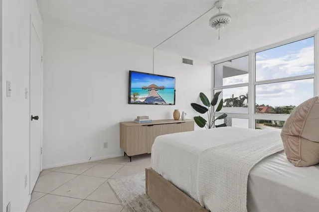 a bed room with a bed and a large window