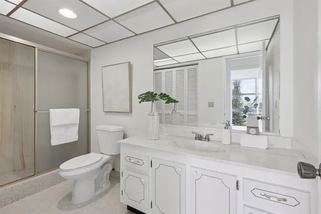 a bathroom with a toilet a sink and shower