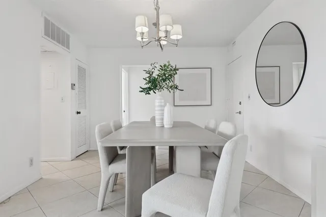 a view of a dining room with furniture and chandelier