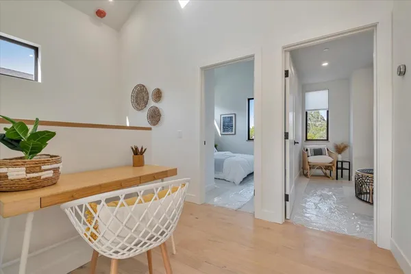 a dining room with furniture and a potted plant