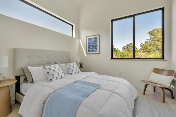 a bedroom with a bed and painting on the wall