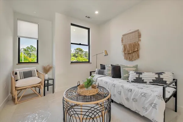 a living room with furniture and a potted plant