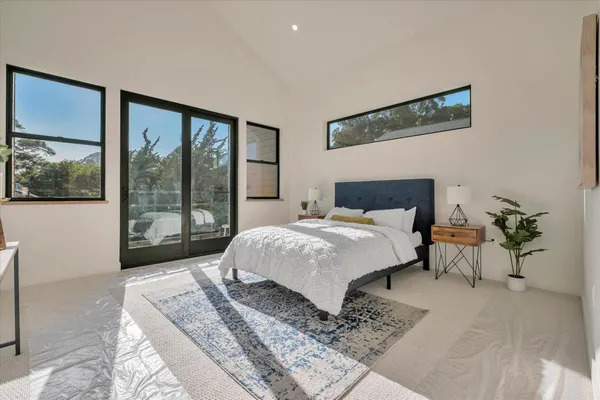 a bedroom with a large bed and a large window