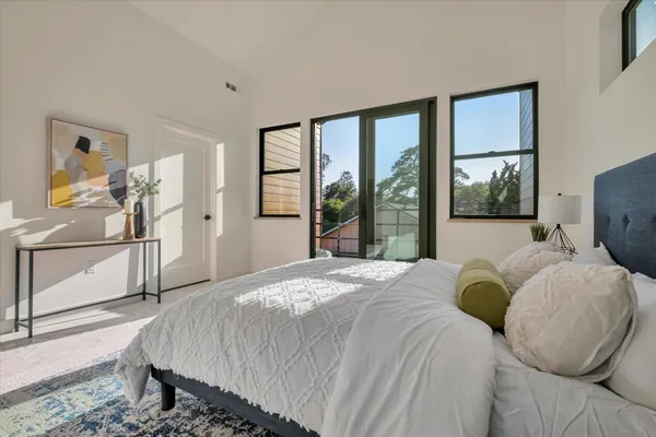 a bed sitting in a bedroom next to a window