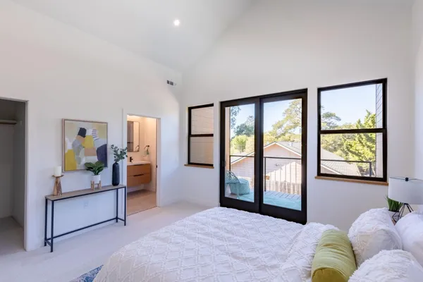 a bedroom with a large bed and a large window