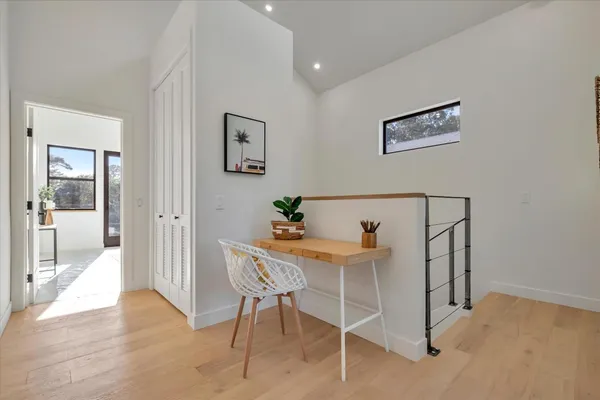 a view of a room with furniture and wooden floor