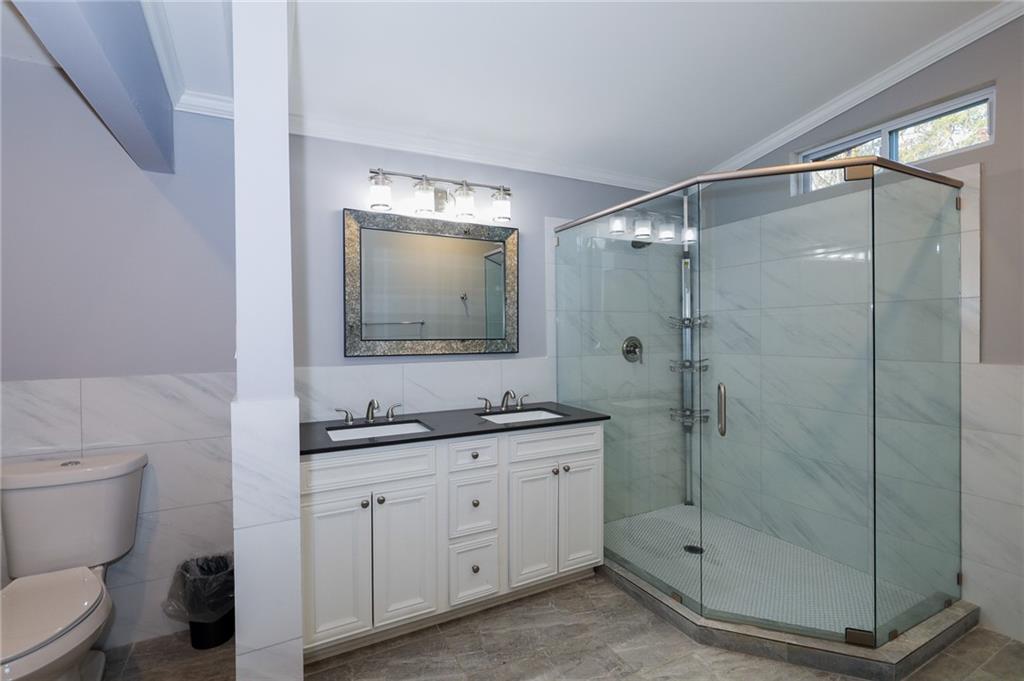 1277 Goodwin Road Northeast, Unit 1271 Atlanta, GA 30324 - Photo 12 of 19 a bathroom with a shower sink mirror and toilet