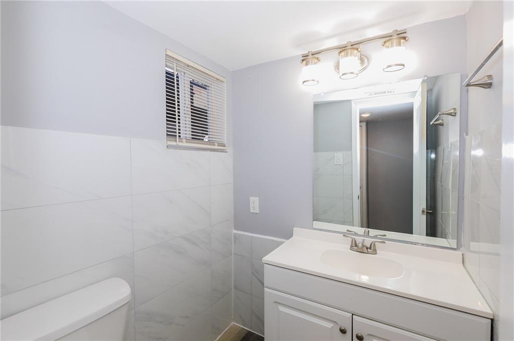 1277 Goodwin Road Northeast, Unit 1271 Atlanta, GA 30324 - Photo 14 of 19 a bathroom with a sink and a toilet