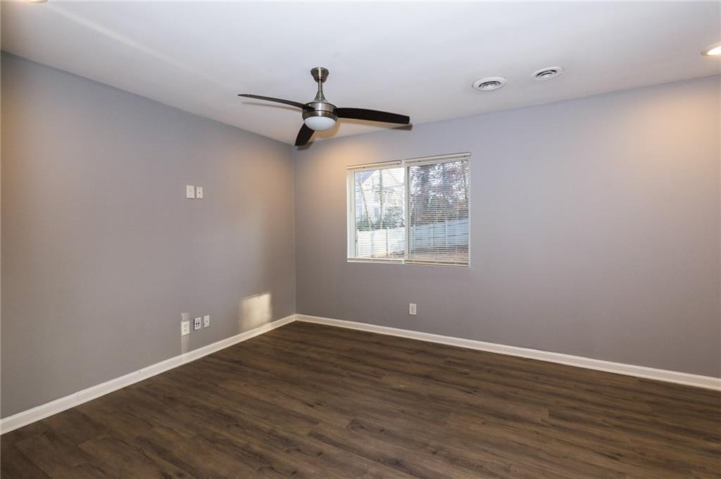 1277 Goodwin Road Northeast, Unit 1271 Atlanta, GA 30324 - Photo 6 of 19 wooden floor in an empty room with a window
