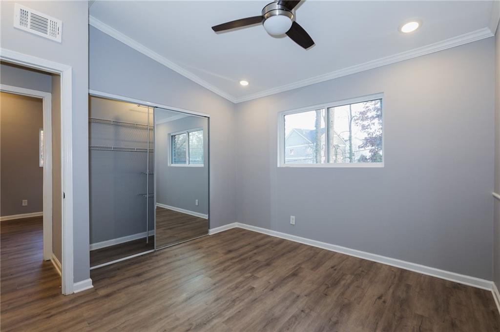 1277 Goodwin Road Northeast, Unit 1271 Atlanta, GA 30324 - Photo 9 of 19 a view of an empty room with wooden floor and a window