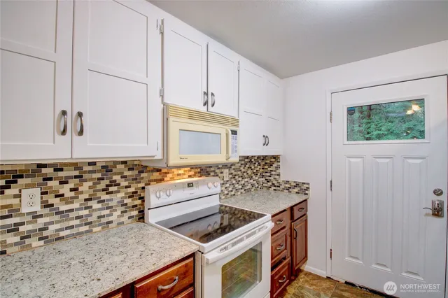 a kitchen with granite countertop a stove and a sink