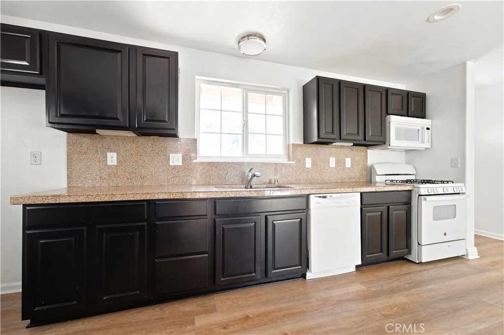 1720 Anderson Street Simi Valley, CA 93065 - Photo 6 of 30 a kitchen with stainless steel appliances granite countertop a sink stove and microwave