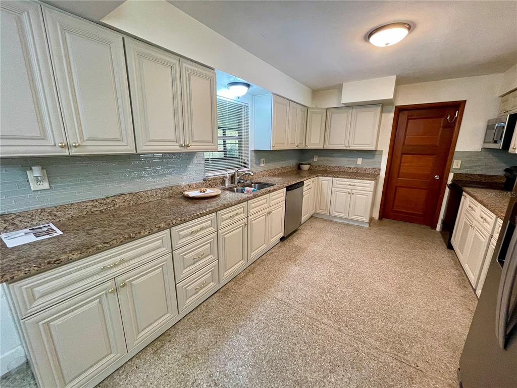 206 Robin Road Altamonte Springs, FL 32701 - Photo 17 of 36 a kitchen with granite countertop white cabinets and white appliances