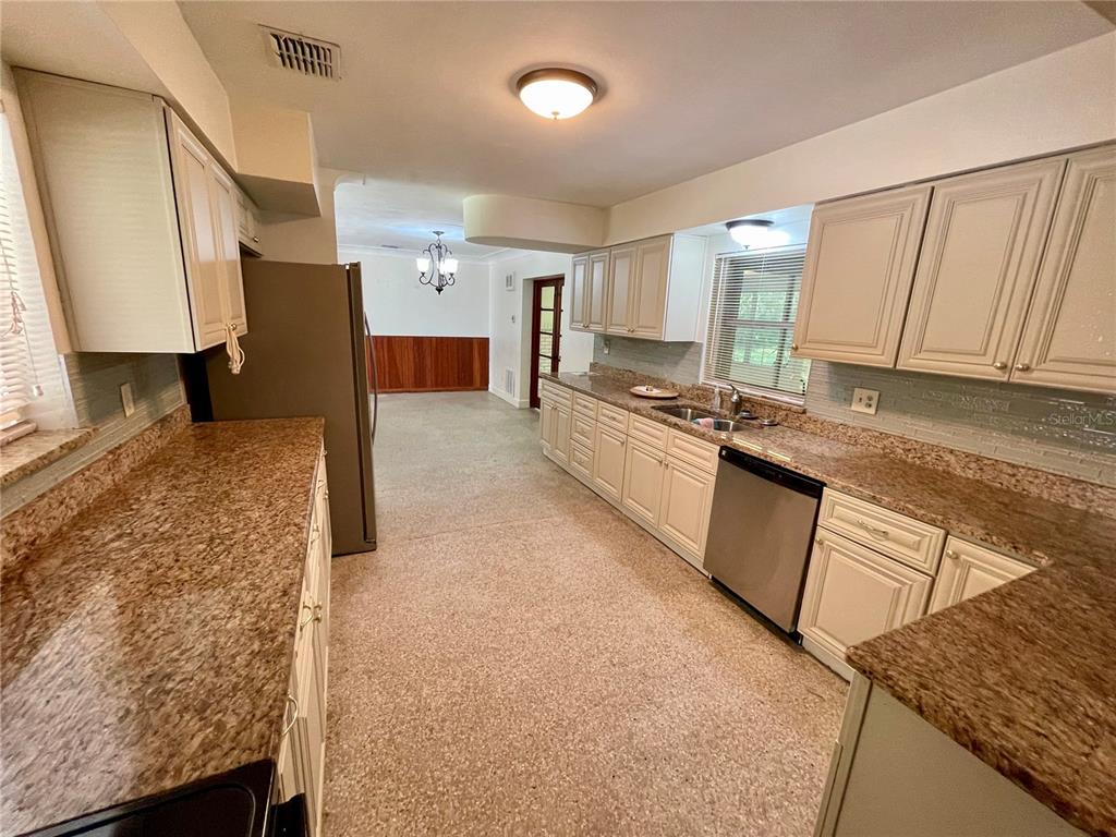 206 Robin Road Altamonte Springs, FL 32701 - Photo 19 of 36 a large kitchen with stainless steel appliances granite countertop a sink stove and cabinets