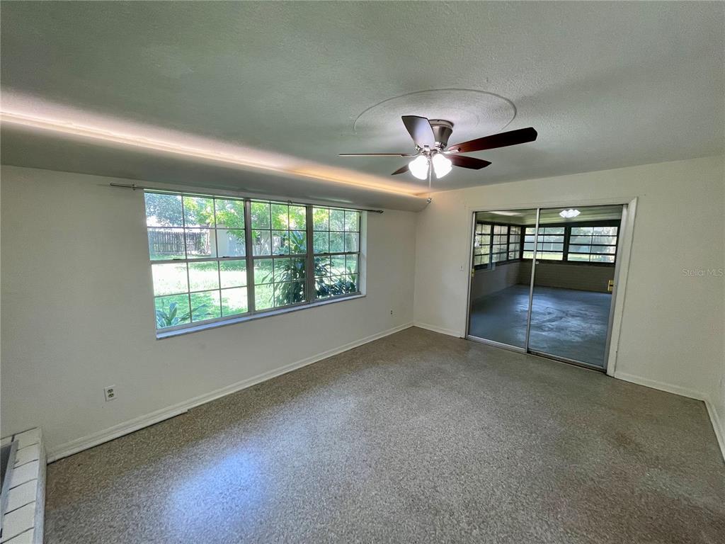 206 Robin Road Altamonte Springs, FL 32701 - Photo 21 of 36 a view of n empty room with window and chandelier fan