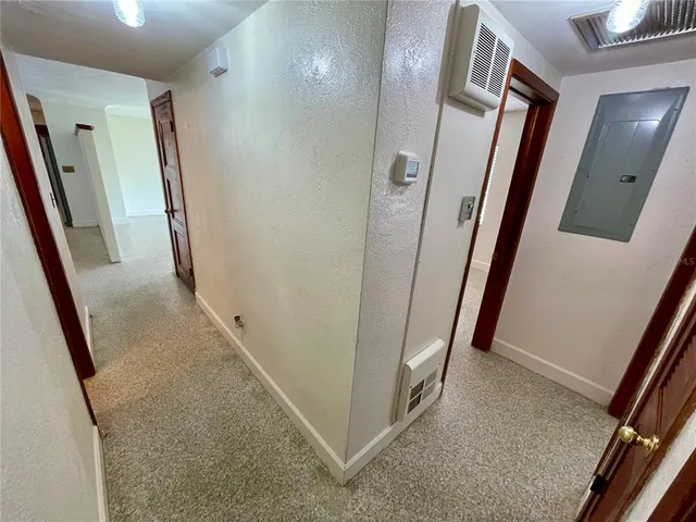 an empty room with a window and a fan
